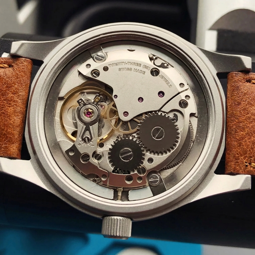 Close-up of a mechanical watch with visible gears and a brown leather strap.